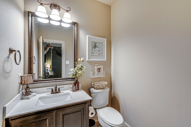 bathroom featuring toilet and vanity