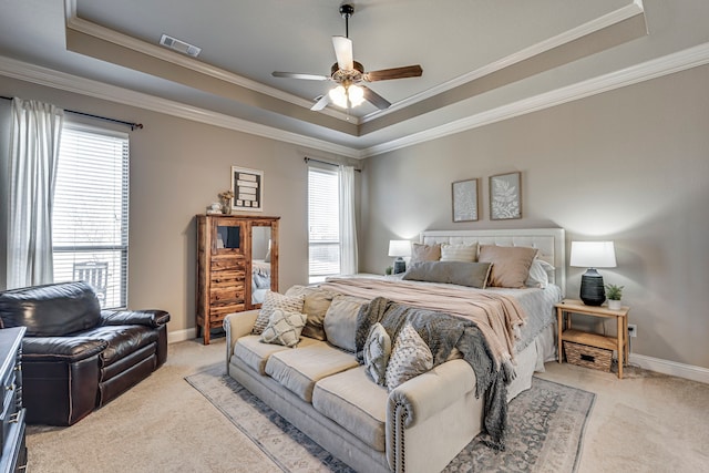 bedroom with light carpet, visible vents, and a raised ceiling