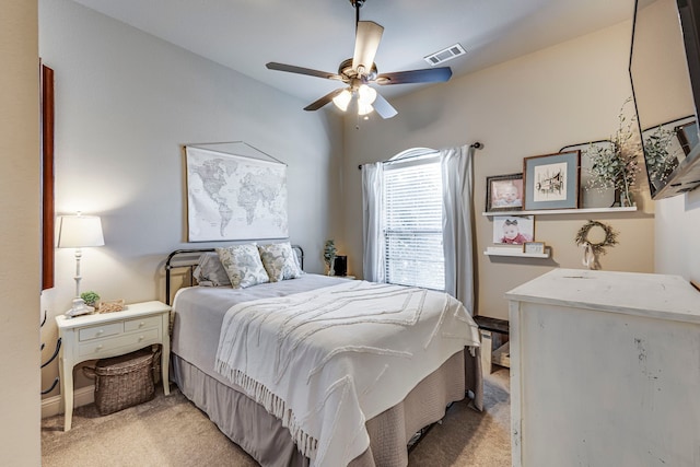 bedroom with ceiling fan, visible vents, and light colored carpet