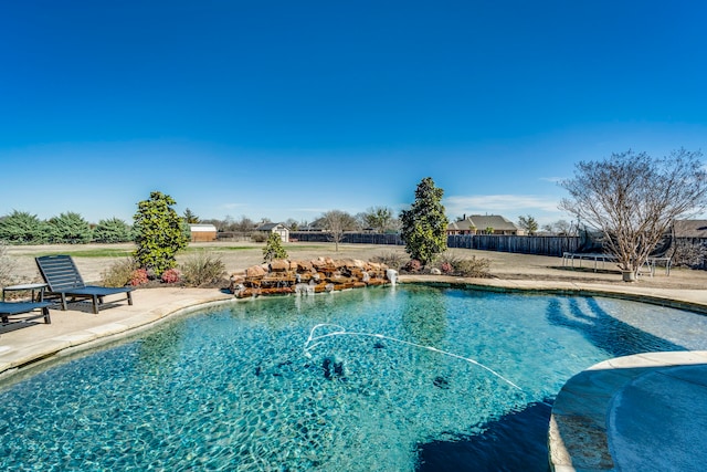 pool with a fenced backyard and a patio