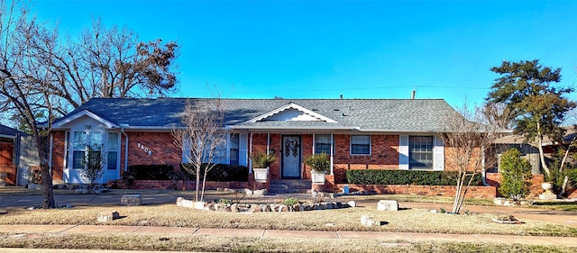 ranch-style house featuring brick siding