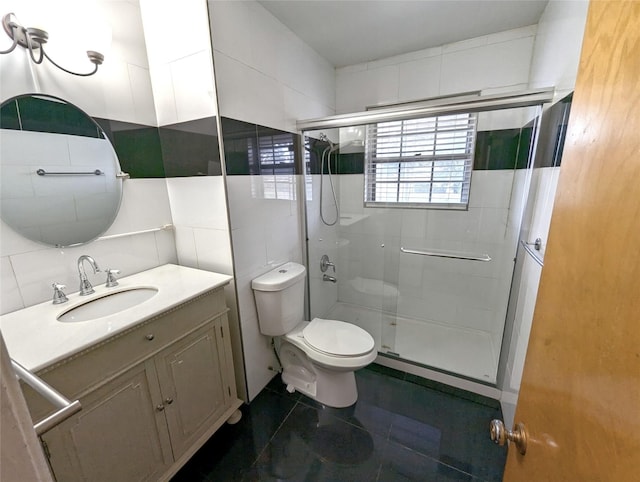 bathroom featuring a stall shower, tile walls, toilet, and vanity