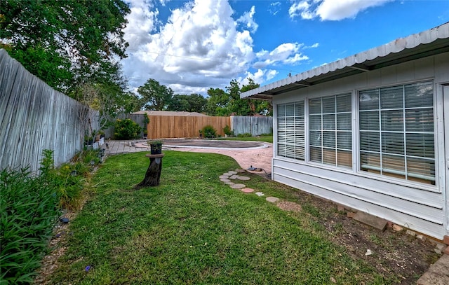 view of yard with a fenced backyard and a patio