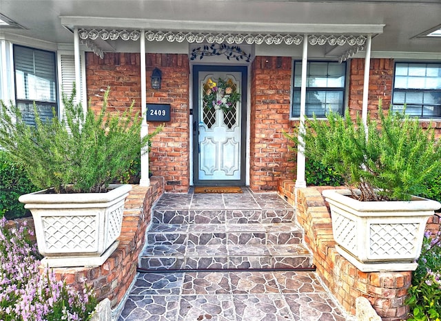 entrance to property featuring brick siding