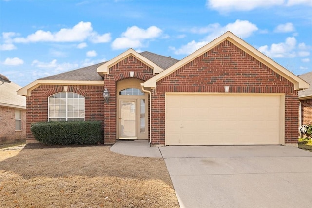 single story home featuring a shingled roof, brick siding, driveway, and an attached garage