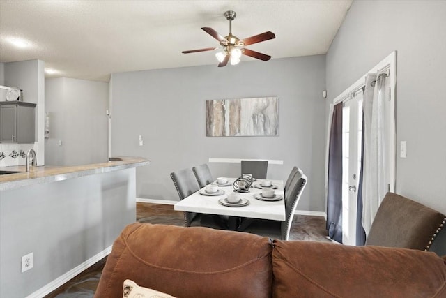 dining room with baseboards and a ceiling fan