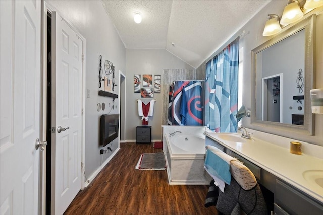 full bathroom with double vanity, a shower with curtain, wood finished floors, a textured ceiling, and a bath