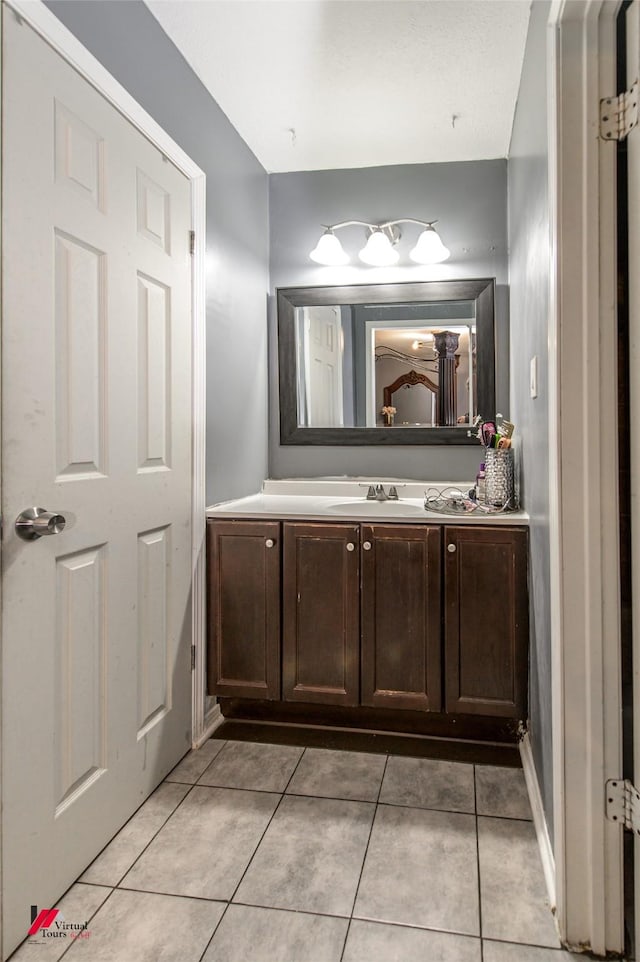 bathroom featuring tile patterned flooring and vanity