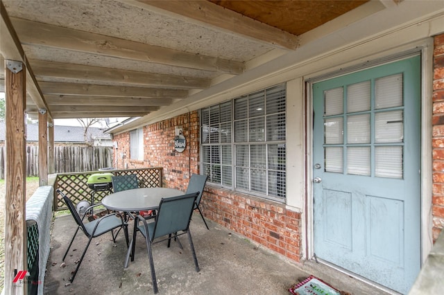 view of patio / terrace featuring outdoor dining space and fence