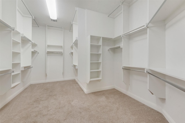 spacious closet with visible vents and light colored carpet