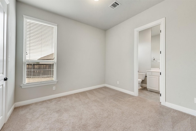 unfurnished bedroom with visible vents, light carpet, baseboards, and multiple windows