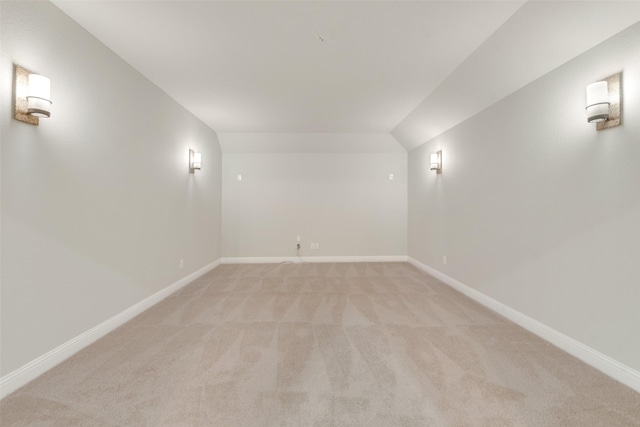 basement featuring light carpet and baseboards