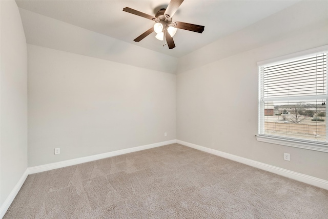 empty room featuring ceiling fan, baseboards, and light colored carpet