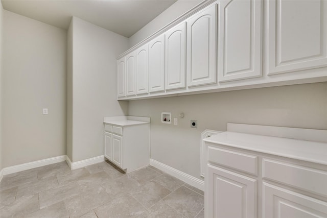 washroom featuring hookup for a washing machine, cabinet space, hookup for an electric dryer, and baseboards