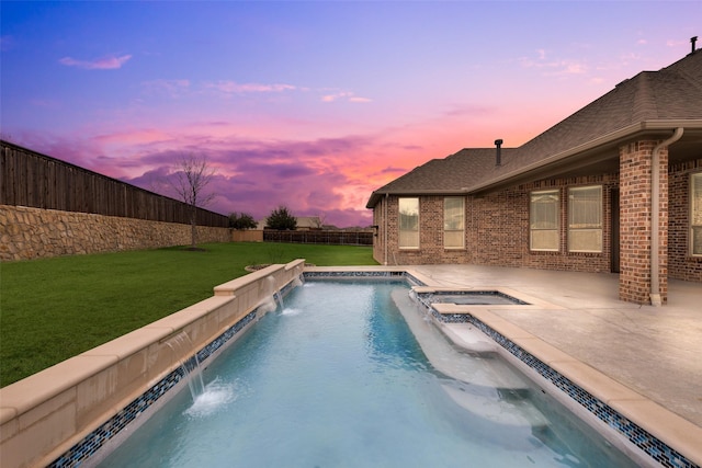 view of pool with a fenced backyard, a pool with connected hot tub, and a lawn