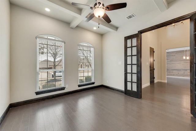 unfurnished room featuring baseboards, visible vents, a ceiling fan, dark wood-type flooring, and beamed ceiling