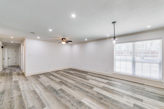 spare room with recessed lighting, visible vents, baseboards, light wood finished floors, and crown molding