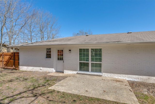 back of property featuring a patio area, brick siding, and fence