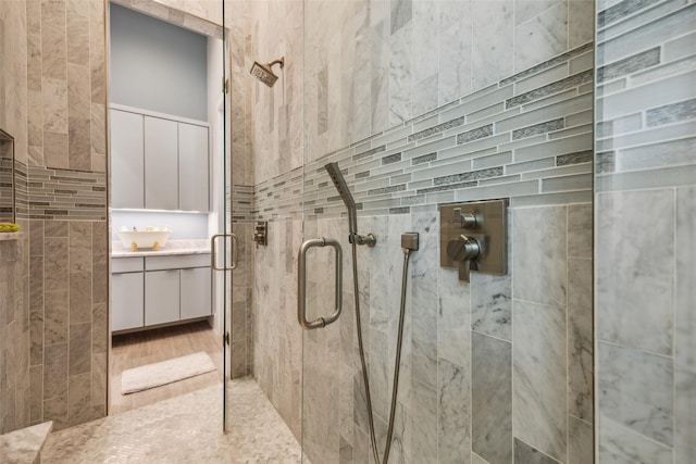 full bathroom featuring a stall shower and vanity