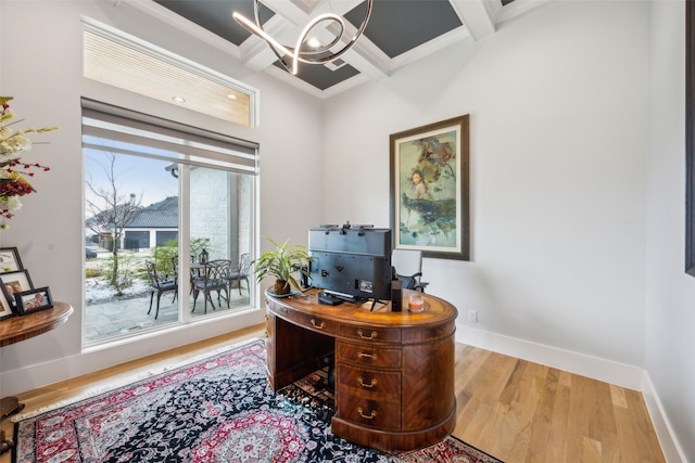 home office featuring beamed ceiling, coffered ceiling, wood finished floors, and baseboards