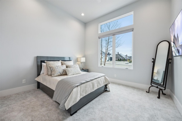 bedroom with baseboards, recessed lighting, and light colored carpet