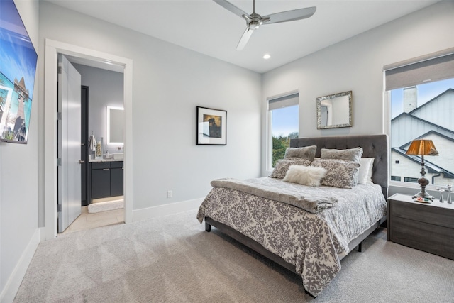 bedroom featuring baseboards, a ceiling fan, light colored carpet, ensuite bathroom, and recessed lighting