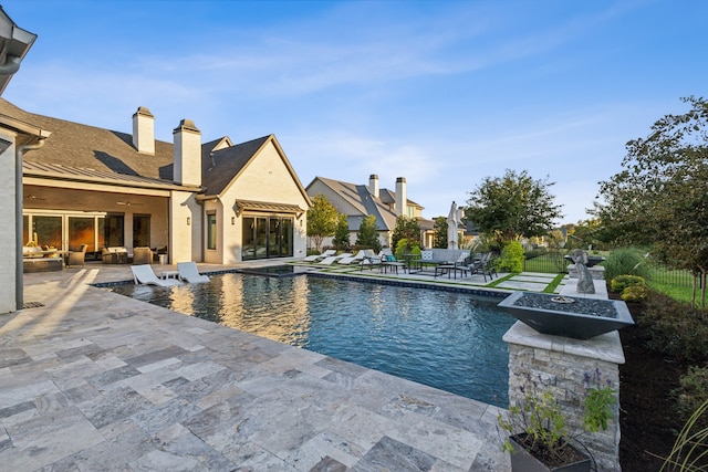 view of swimming pool featuring a patio, fence, and a fenced in pool