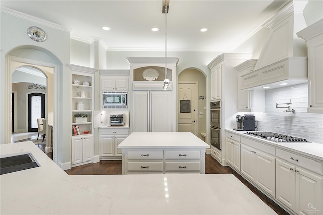 kitchen featuring appliances with stainless steel finishes, white cabinetry, decorative light fixtures, and open shelves