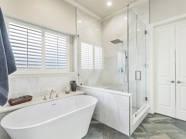 full bath with marble finish floor, a soaking tub, a shower stall, and crown molding