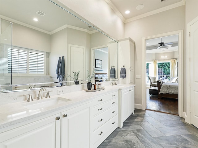 ensuite bathroom with ensuite bathroom, a sink, visible vents, ornamental molding, and double vanity