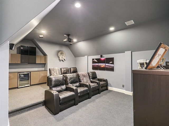 home theater room with light carpet, wine cooler, baseboards, and vaulted ceiling