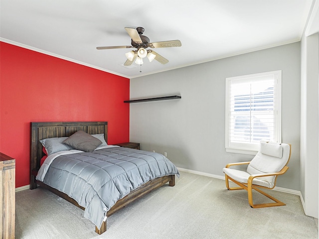 carpeted bedroom featuring baseboards, a ceiling fan, and ornamental molding