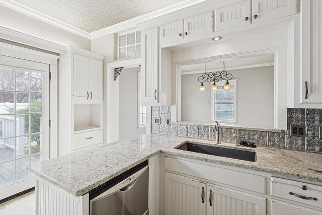 111 S Pine St, Roanoke, TX 76262 - kitchen with light stone countertops, white cabinetry, ornamental molding, appliances with stainless steel finishes, and a sink