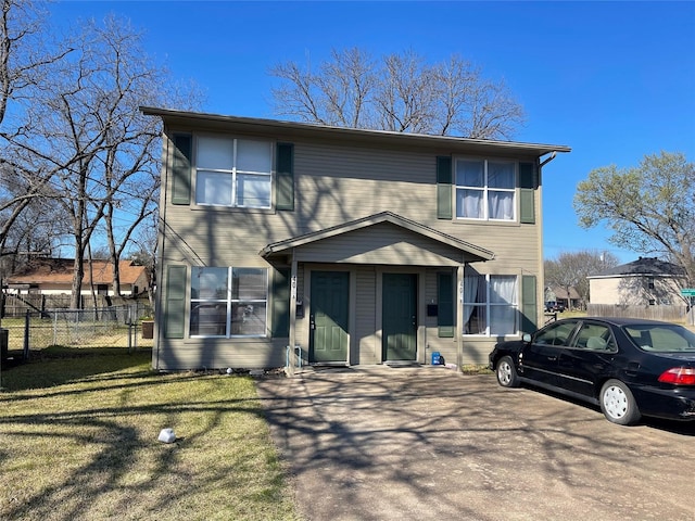 view of front of house with fence and a front lawn