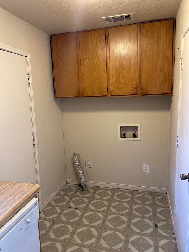 laundry room with baseboards, cabinet space, visible vents, and light floors