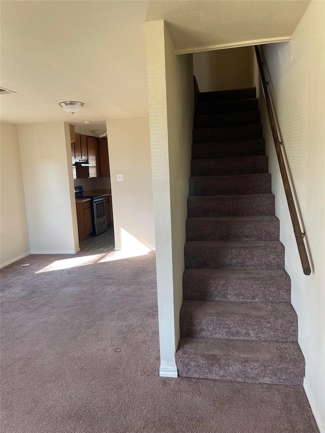 stairway featuring carpet flooring, visible vents, and baseboards