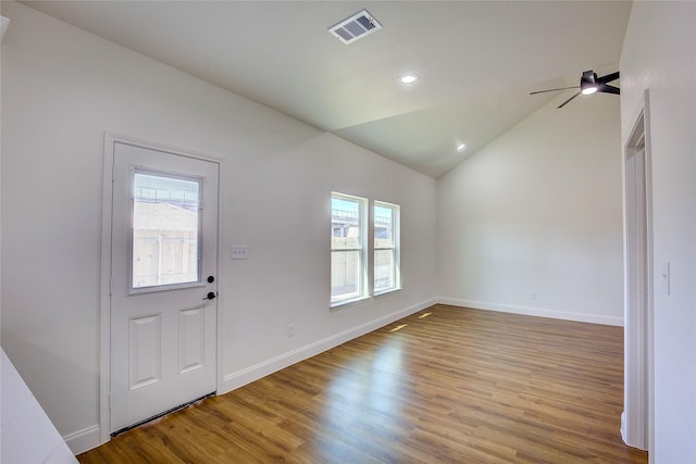 entryway featuring lofted ceiling, light wood-style floors, visible vents, and a wealth of natural light