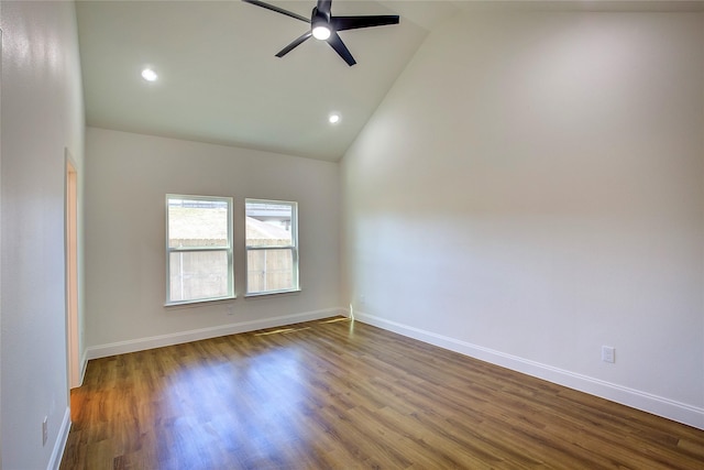 empty room with high vaulted ceiling, ceiling fan, baseboards, and wood finished floors