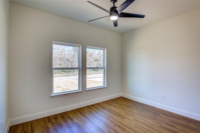 spare room with a ceiling fan, baseboards, and wood finished floors