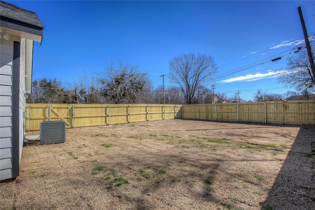 view of yard featuring central air condition unit and a fenced backyard