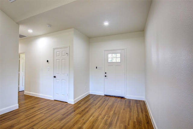 entryway featuring visible vents, baseboards, and dark wood-style flooring