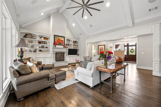6611 Dartbrook Dr, Dallas, TX 75254 - living room featuring beamed ceiling, dark wood-style flooring, built in features, ceiling fan, and a fireplace with raised hearth