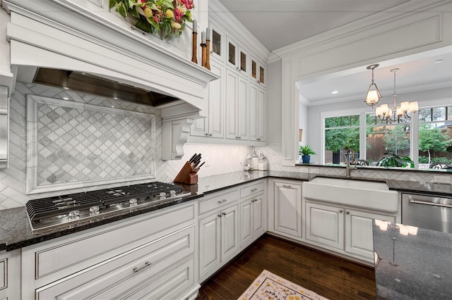 6611 Dartbrook Dr, Dallas, TX 75254 - kitchen featuring a sink, appliances with stainless steel finishes, decorative backsplash, custom range hood, and dark wood-type flooring