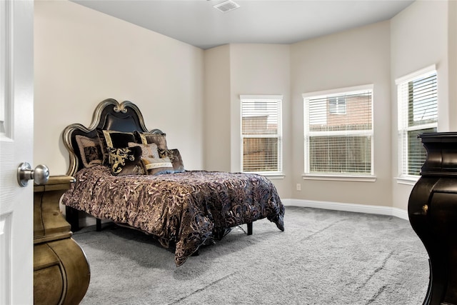 carpeted bedroom with visible vents and baseboards