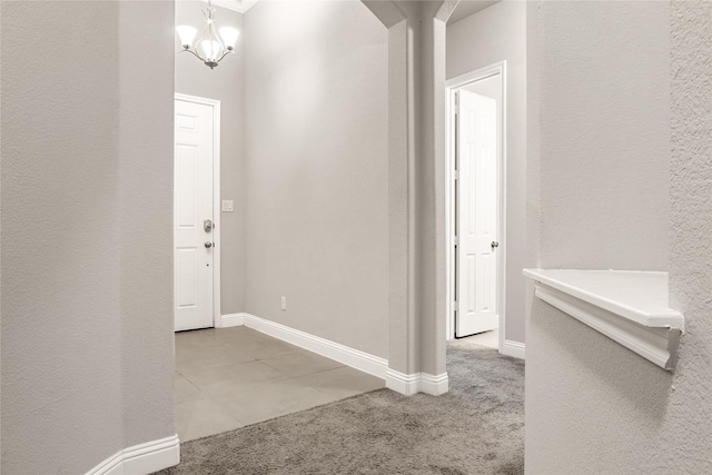 carpeted foyer entrance featuring baseboards