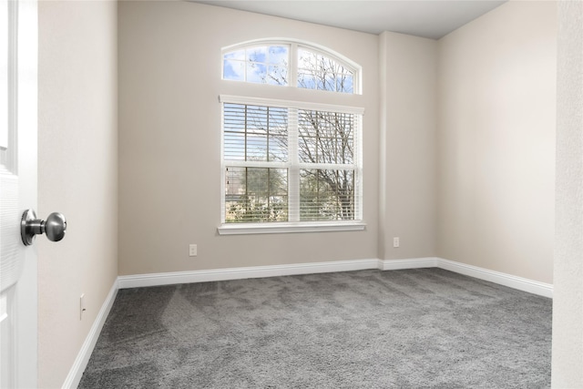 empty room with carpet and baseboards