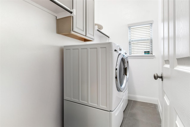 laundry room featuring tile patterned flooring, cabinet space, and baseboards