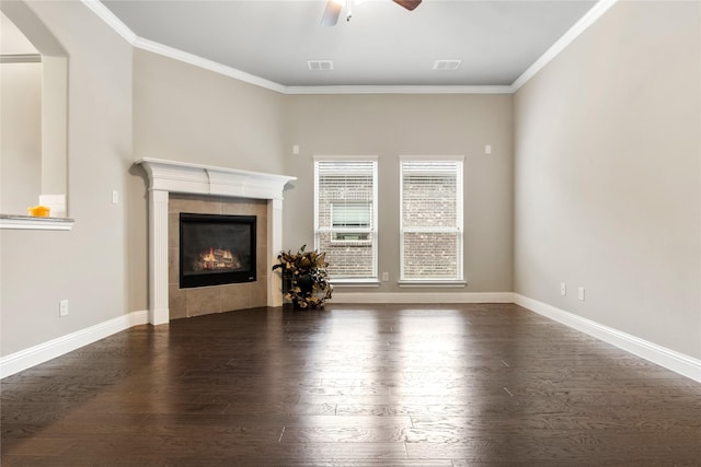 unfurnished living room with ornamental molding, dark wood-style flooring, a tile fireplace, and visible vents