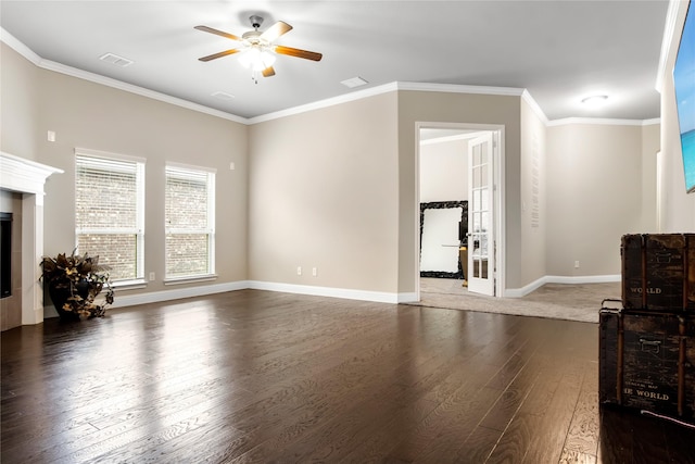 living room with dark wood-style floors, ornamental molding, a tiled fireplace, and visible vents