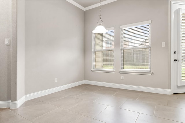 unfurnished dining area featuring baseboards, crown molding, and light tile patterned flooring